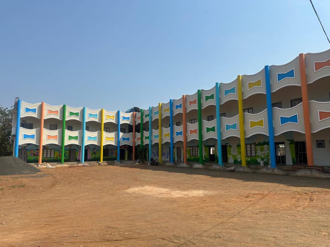 Long two-storey school building with coloured pillars